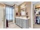 Chic bathroom featuring a gray vanity, decorative mirror, and a glass-enclosed shower at 3115 Cross Vine Ln, Summerville, SC 29483