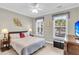 Comfortable bedroom features two windows, ceiling fan, dresser with TV, and stylish lamps at 3115 Cross Vine Ln, Summerville, SC 29483
