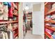 Spacious walk-in closet with wooden shelving and storage racks for clothes and accessories at 3115 Cross Vine Ln, Summerville, SC 29483