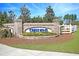 Community entrance sign featuring brick pillars, a landscaped flower bed, and clear signage at 3115 Cross Vine Ln, Summerville, SC 29483