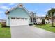 Charming blue home featuring a spacious two-car garage and a beautifully landscaped front yard with a palm tree at 3115 Cross Vine Ln, Summerville, SC 29483