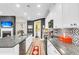 Stylish kitchen featuring granite countertops, stainless steel appliances, and easy access to the living area with fireplace at 3115 Cross Vine Ln, Summerville, SC 29483