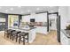 Modern kitchen boasts white cabinetry, granite countertops, stainless steel appliances, and a large island with seating at 3115 Cross Vine Ln, Summerville, SC 29483