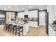 Contemporary kitchen features white cabinetry, granite counters, stainless appliances, and an expansive island with seating at 3115 Cross Vine Ln, Summerville, SC 29483