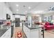 Open kitchen with a large island, granite countertops, modern appliances, and seamless flow to living and dining areas at 3115 Cross Vine Ln, Summerville, SC 29483