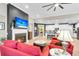 Open-concept living room with fireplace, TV, seamlessly connected to a modern kitchen with bar seating at 3115 Cross Vine Ln, Summerville, SC 29483