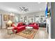 Spacious living room featuring red sofas, a decorative rug, and ample natural light from large windows at 3115 Cross Vine Ln, Summerville, SC 29483