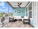 Screened porch features tile floors, white furniture, ceiling fan and views of the lush backyard at 3115 Cross Vine Ln, Summerville, SC 29483