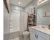 Well-lit bathroom with a shower-tub, modern fixtures, and decorative shelving and artwork at 315 Silent Bluff Dr, Summerville, SC 29486