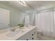 Well-lit bathroom with double sinks, and a shower featuring a white shower curtain at 315 Silent Bluff Dr, Summerville, SC 29486