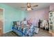 Colorful bedroom with a bed, turquoise and pink walls and a ceiling fan at 315 Silent Bluff Dr, Summerville, SC 29486