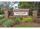 The Sanctuary Cove brick community entrance sign surrounded by lush landscaping at 315 Silent Bluff Dr, Summerville, SC 29486