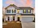 Beautiful two-story home with a manicured lawn, a two-car garage, and a welcoming front porch at 315 Silent Bluff Dr, Summerville, SC 29486