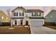 Inviting two-story home with a manicured lawn, showcasing a welcoming front porch and attached garage at 315 Silent Bluff Dr, Summerville, SC 29486