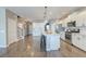 Open-concept kitchen with white cabinets, stainless appliances, granite island, and hardwood floors at 315 Silent Bluff Dr, Summerville, SC 29486