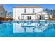 Refreshing pool with a reflection of the home, complemented by a lush green yard and blue skies at 315 Silent Bluff Dr, Summerville, SC 29486