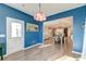 Sitting room has blue accent wall, stylish light fixture and a door to the outside at 315 Silent Bluff Dr, Summerville, SC 29486