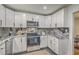 Modern kitchen features white cabinetry, stainless steel appliances, and stone countertops at 337 Cessna Ave, Charleston, SC 29407