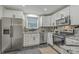Bright kitchen with stainless steel appliances, stone countertops, and white cabinets at 337 Cessna Ave, Charleston, SC 29407