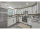 Modern kitchen featuring sleek stainless steel appliances, white cabinets, and stylish countertops at 337 Cessna Ave, Charleston, SC 29407