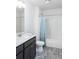 Bathroom featuring a single sink vanity, grey tile floors, and a shower tub combo with a shower curtain at 338 Hillman Trail Dr, Moncks Corner, SC 29461