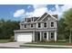 New two-story home featuring a two-car garage, dormer windows and landscaped front yard at 346 Hillman Trail Dr, Moncks Corner, SC 29461