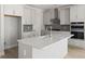 Gorgeous kitchen with stainless steel appliances, white cabinets, island, and tiled backsplash at 346 Hillman Trail Dr, Moncks Corner, SC 29461