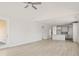 Open-concept living area with light wood floors leading to a kitchen with a breakfast bar at 346 Hillman Trail Dr, Moncks Corner, SC 29461