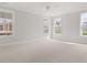 Large, naturally-lit bedroom with large windows, carpet flooring, and white trim at 346 Hillman Trail Dr, Moncks Corner, SC 29461