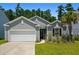 Charming single-story home featuring a well-manicured lawn, attached garage, and classic gray siding at 350 Bering Ln, Summerville, SC 29486