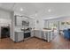 Modern kitchen features stainless steel appliances, gray cabinets, and an adjacent dining area at 350 Bering Ln, Summerville, SC 29486