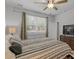 Tranquil main bedroom featuring a ceiling fan, large window, and a dresser with a flat-screen TV at 350 Bering Ln, Summerville, SC 29486