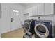 Bright laundry room featuring modern appliances, ample cabinet space, and outdoor access at 3592 Somerset Hills Ct, Mount Pleasant, SC 29466