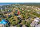 Beautiful aerial view of a quaint home nestled among lush trees near a golf course and ocean at 3619 Loggerhead Ct, Seabrook Island, SC 29455