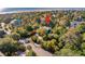 Aerial shot of a home surrounded by lush greenery in a peaceful, wooded neighborhood at 3619 Loggerhead Ct, Seabrook Island, SC 29455