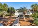 Backyard view of a two-story house with a deck, palm trees, and shade at 3619 Loggerhead Ct, Seabrook Island, SC 29455