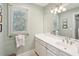 Bright bathroom featuring a large mirror and a sleek white vanity at 3619 Loggerhead Ct, Seabrook Island, SC 29455