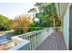 Side angle from wooden porch with a view of the lawn and trees at 3619 Loggerhead Ct, Seabrook Island, SC 29455