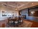 Elegant dining room boasting a large round table, coffered ceiling, fireplace, and built-in shelves for storage at 3619 Loggerhead Ct, Seabrook Island, SC 29455