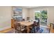 Traditional dining room with a wooden table, chairs, and a sideboard, with a view of the outdoor scenery at 3619 Loggerhead Ct, Seabrook Island, SC 29455