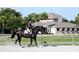 Person riding a black horse in a training area near the barn at 3619 Loggerhead Ct, Seabrook Island, SC 29455