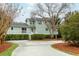 Two-story home featuring well-maintained landscaping, including a curved driveway and a cozy front porch at 3619 Loggerhead Ct, Seabrook Island, SC 29455