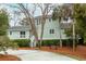 Inviting two-story house with a front porch, surrounded by mature trees and neat shrubbery at 3619 Loggerhead Ct, Seabrook Island, SC 29455