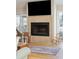Close-up of fireplace with a tile surround in a light-filled living room with hardwood floors and outdoor access at 3619 Loggerhead Ct, Seabrook Island, SC 29455