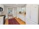 Open kitchen with white cabinets, stainless appliances, tile backsplash and hardwood floors at 3619 Loggerhead Ct, Seabrook Island, SC 29455