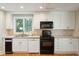 Kitchen featuring stainless appliances, white cabinets, tile backsplash, and hardwood floors at 3619 Loggerhead Ct, Seabrook Island, SC 29455