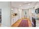 Bright kitchen featuring white cabinets, stainless appliances, a large window, and hardwood floors at 3619 Loggerhead Ct, Seabrook Island, SC 29455