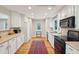 Bright kitchen with updated appliances, white cabinets, hardwood floors and recessed lighting at 3619 Loggerhead Ct, Seabrook Island, SC 29455
