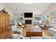 Open living room featuring a fireplace, vaulted ceilings, ceiling fans, and access to the outdoors at 3619 Loggerhead Ct, Seabrook Island, SC 29455