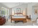 Inviting main bedroom showcasing a large window and a rustic bench at the foot of the bed at 3619 Loggerhead Ct, Seabrook Island, SC 29455